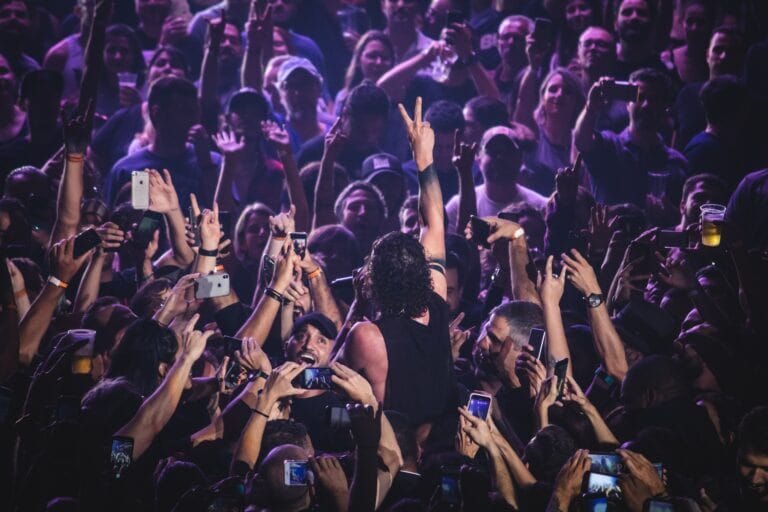 A crowd of people at a concert, building loyal fans.